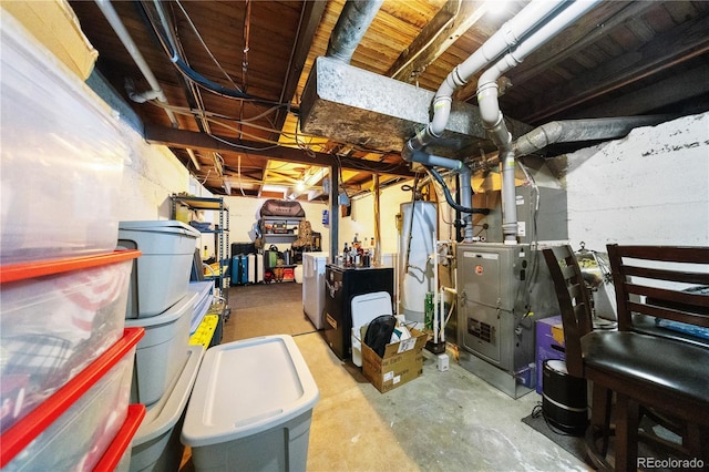 unfinished below grade area featuring heating unit and water heater