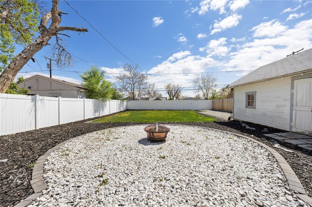 view of yard featuring a fenced backyard and an outdoor fire pit