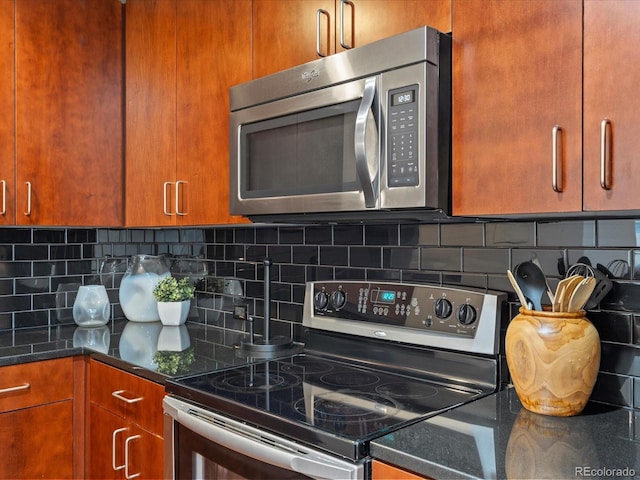 kitchen featuring tasteful backsplash, dark stone counters, and stainless steel appliances