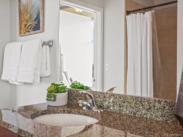 bathroom with a shower with curtain and vanity