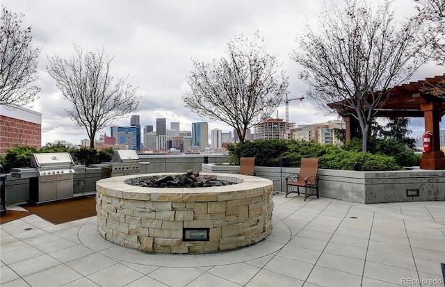 view of patio with a fire pit, a grill, and area for grilling