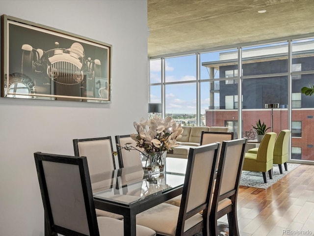 dining area featuring expansive windows and wood-type flooring