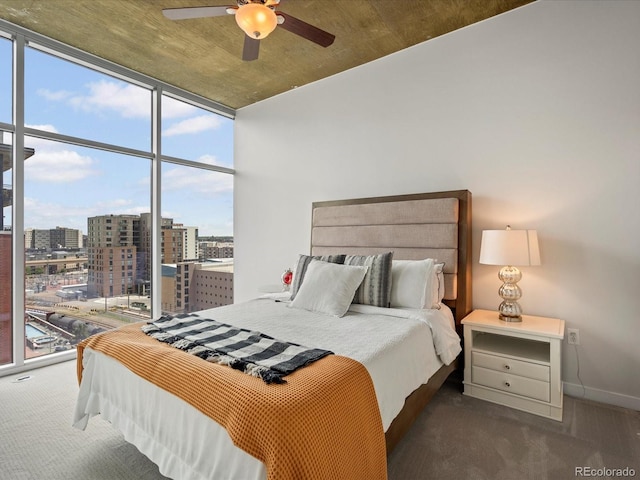 bedroom with a wall of windows, multiple windows, and ceiling fan