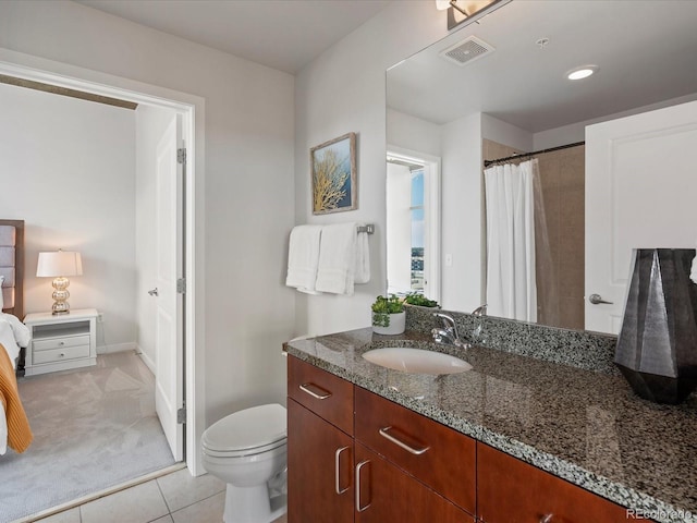 bathroom featuring tile patterned floors, vanity, and toilet