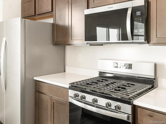 kitchen with dark brown cabinets and stainless steel appliances