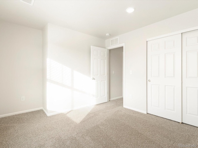 unfurnished bedroom featuring a closet and carpet floors