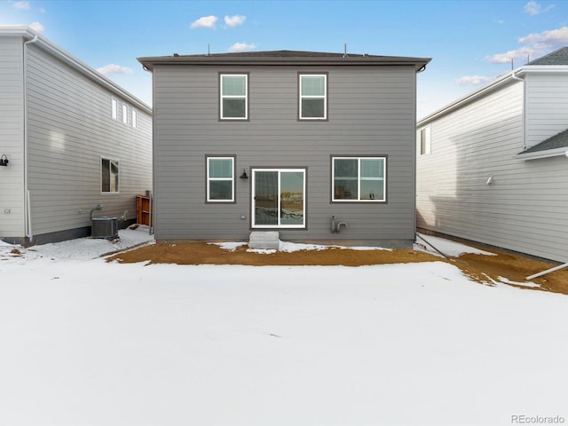 snow covered house with cooling unit