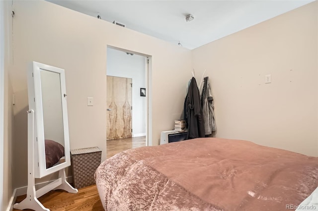 bedroom featuring visible vents and light wood-style flooring