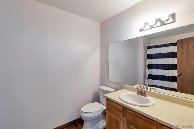 3407 S Ammons St Unit 20-2, Lakewood, CO 80227 - bathroom with toilet, vanity, wood finished floors, and baseboards