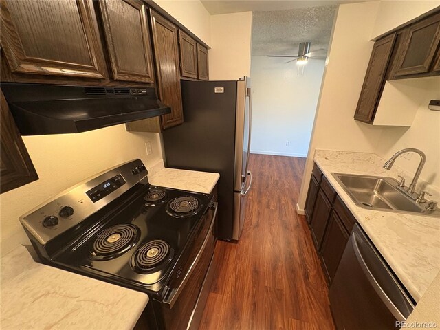 6905 Mariposa St Unit B, Denver, CO 80221 - kitchen featuring stainless steel appliances, under cabinet range hood, dark wood-type flooring, dark brown cabinets, and light countertops