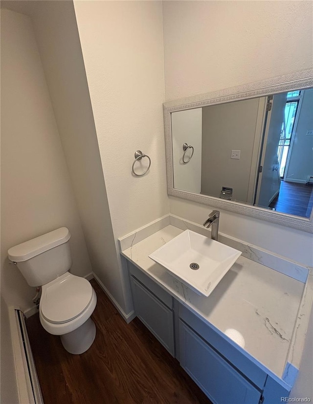 6905 Mariposa St Unit B, Denver, CO 80221 - half bathroom featuring wood finished floors and vanity