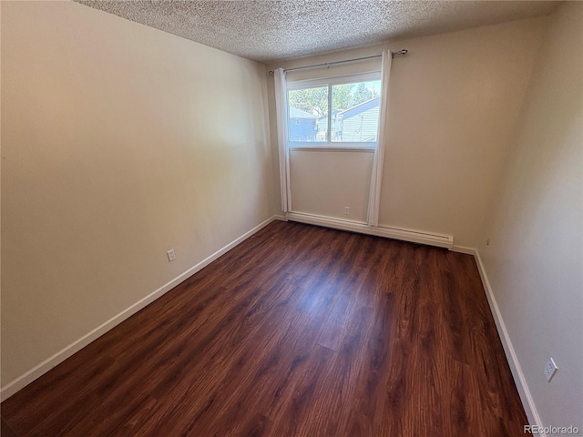6905 Mariposa St Unit B, Denver, CO 80221 - unfurnished room featuring a textured ceiling, dark wood-style floors, and baseboard heating