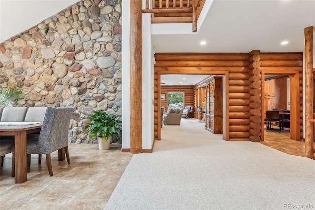 dining room featuring rustic walls, carpet, and recessed lighting