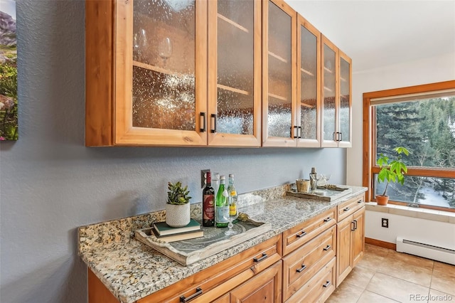 bar featuring light tile patterned floors and a baseboard heating unit