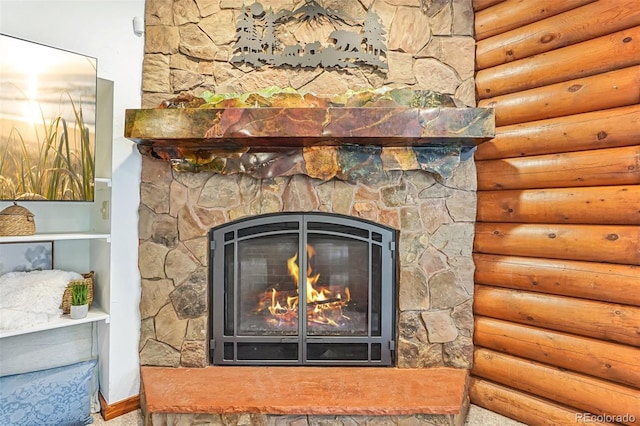 interior details featuring a fireplace and log walls