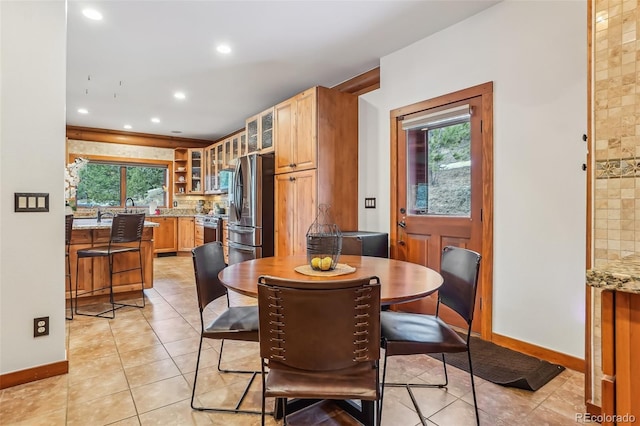 dining space featuring light tile patterned floors, plenty of natural light, baseboards, and recessed lighting