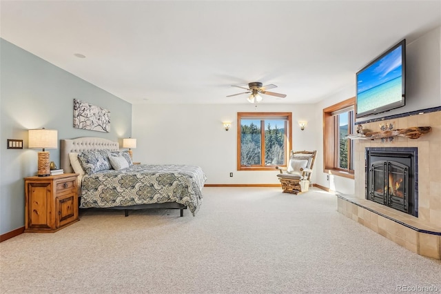 bedroom featuring carpet flooring, a fireplace, baseboards, and ceiling fan