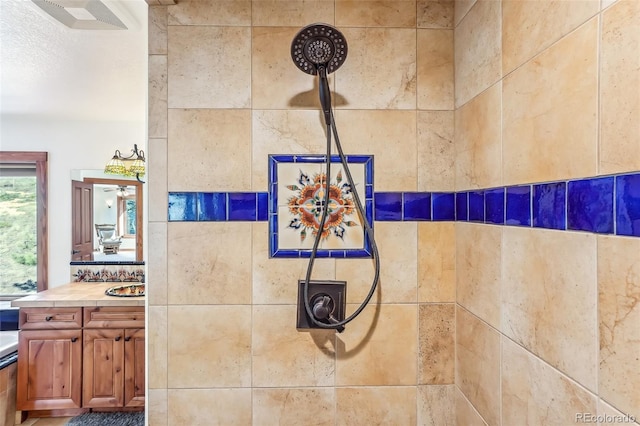 room details featuring a tile shower and vanity