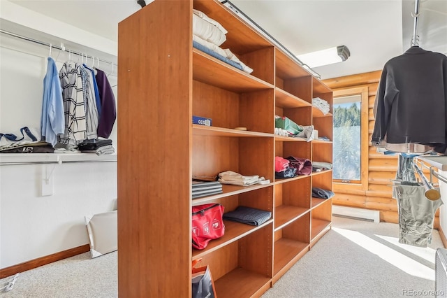 spacious closet with carpet and baseboard heating