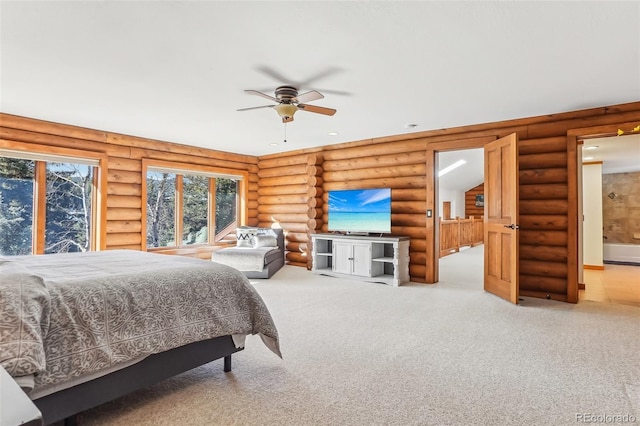 carpeted bedroom with ensuite bath, log walls, and a ceiling fan