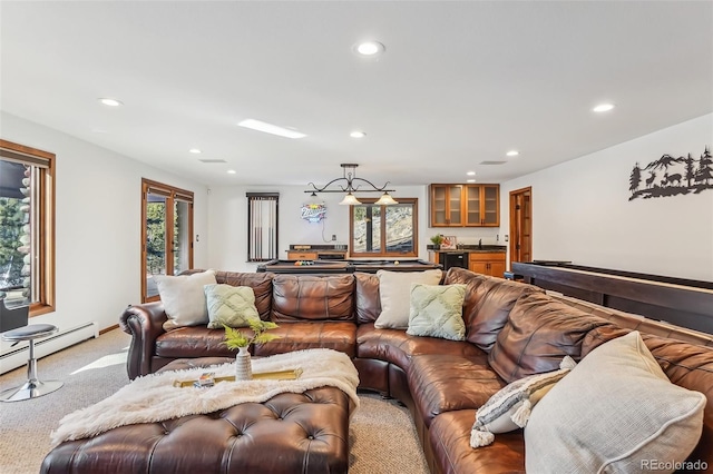 carpeted living area with a baseboard heating unit, recessed lighting, and a sink