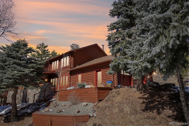 property exterior at dusk featuring log exterior