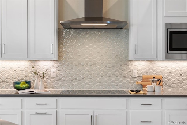 10295 E 59th Ave, Denver, CO 80238 - kitchen with wall chimney range hood, stainless steel microwave, dark countertops, and backsplash