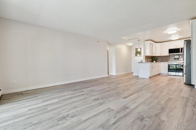 kitchen featuring appliances with stainless steel finishes and light hardwood / wood-style flooring