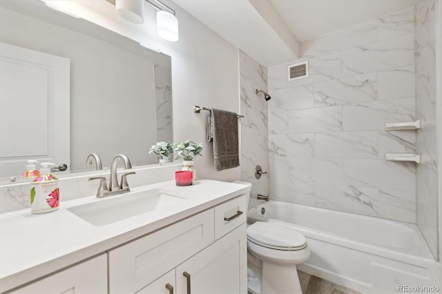 full bathroom featuring toilet, vanity, and tiled shower / bath