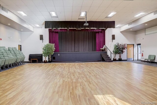 miscellaneous room featuring a drop ceiling and wood-type flooring