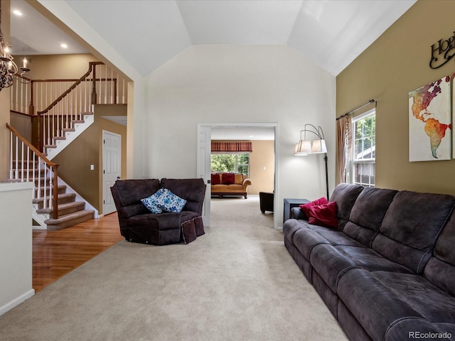 8953 W Brandt Pl, Littleton, CO 80123 - carpeted living area with plenty of natural light, stairway, high vaulted ceiling, a chandelier, and recessed lighting