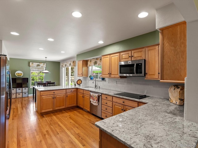 8953 W Brandt Pl, Littleton, CO 80123 - kitchen featuring stainless steel appliances, a peninsula, decorative backsplash, light wood finished floors, and light stone countertops