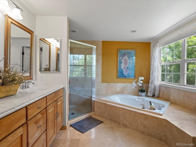 8953 W Brandt Pl, Littleton, CO 80123 - bathroom with vanity, a garden tub, a stall shower, and tile patterned floors