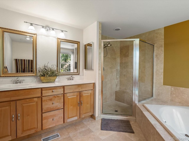 8953 W Brandt Pl, Littleton, CO 80123 - full bathroom with a stall shower, double vanity, a bath, and tile patterned flooring