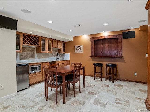8953 W Brandt Pl, Littleton, CO 80123 - dining space featuring bar with sink and recessed lighting