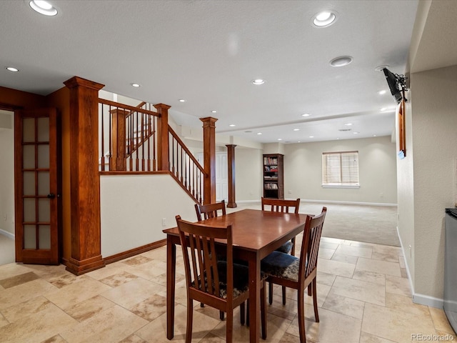 8953 W Brandt Pl, Littleton, CO 80123 - dining area featuring stone tile flooring, recessed lighting, decorative columns, and stairway