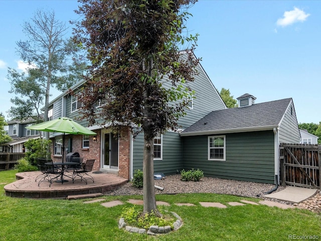 8953 W Brandt Pl, Littleton, CO 80123 - back of house with a patio area and roof with shingles