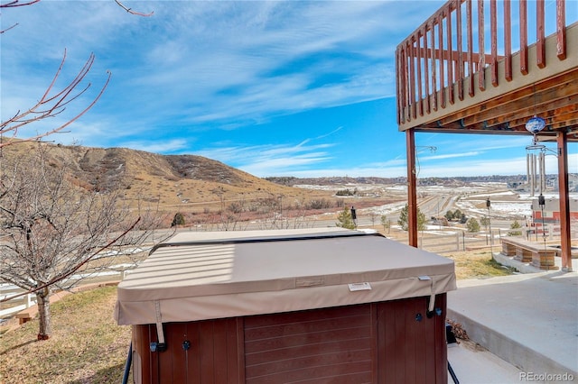 view of yard with a hot tub and a mountain view