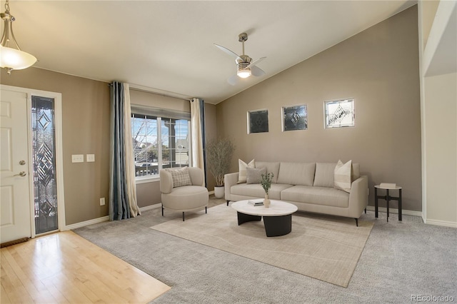 carpeted living room featuring vaulted ceiling and ceiling fan