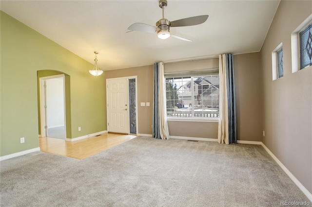 carpeted spare room with lofted ceiling and ceiling fan