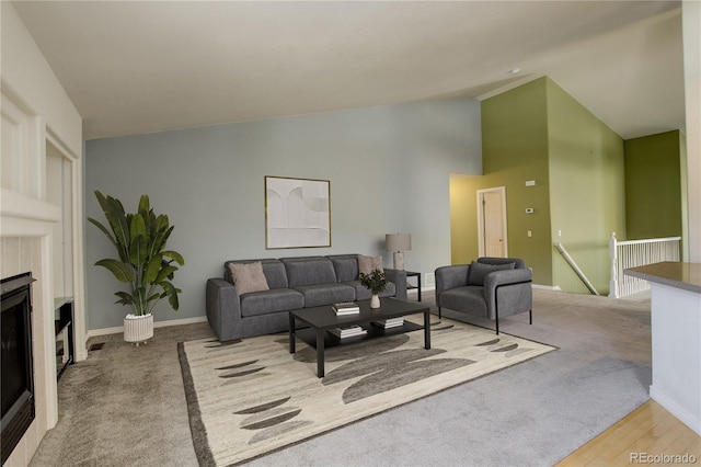 living room with light colored carpet and high vaulted ceiling