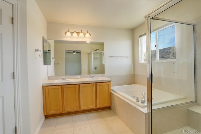 bathroom featuring independent shower and bath, vanity, and tile patterned floors