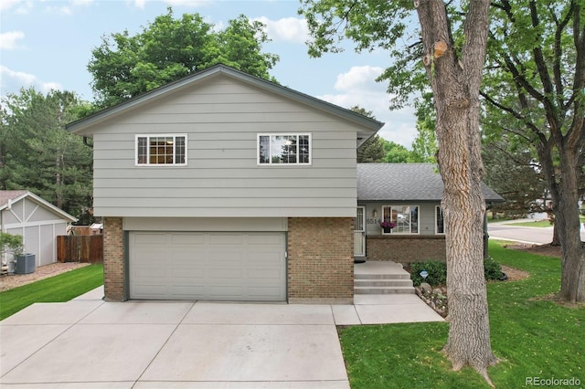 6514 Zinnia St, Arvada, CO 80004 - split level home featuring brick siding, an attached garage, and driveway
