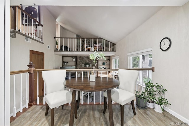 6514 Zinnia St, Arvada, CO 80004 - dining room featuring wood finished floors and high vaulted ceiling