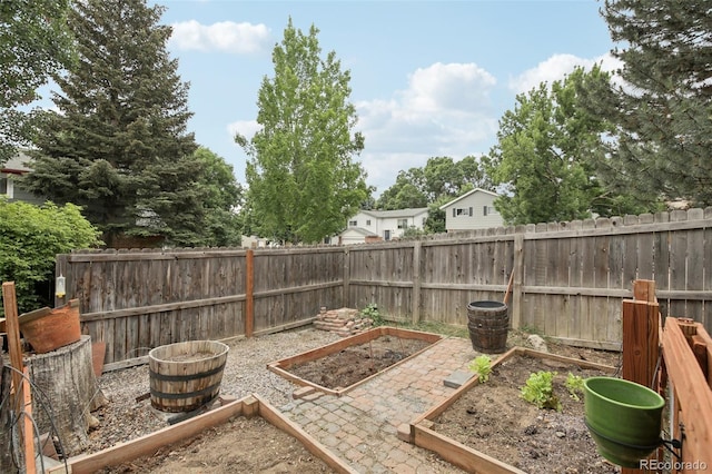6514 Zinnia St, Arvada, CO 80004 - fenced backyard featuring a vegetable garden