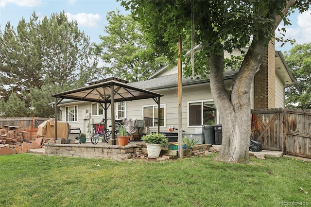 6514 Zinnia St, Arvada, CO 80004 - rear view of property featuring a fenced backyard, a patio area, and a shingled roof