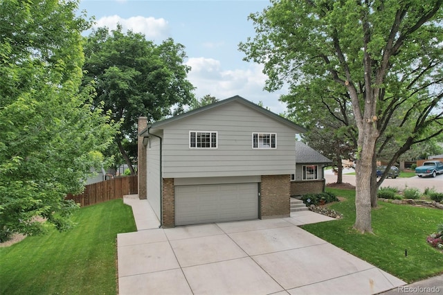 6514 Zinnia St, Arvada, CO 80004 - view of front facade with brick siding, a garage, driveway, and a chimney
