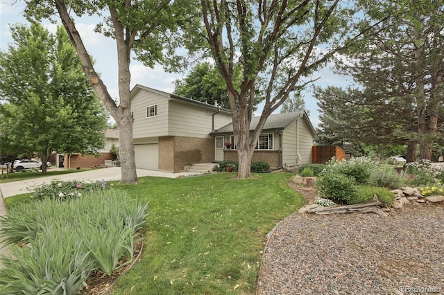 6514 Zinnia St, Arvada, CO 80004 - view of front of property with driveway, brick siding, a front lawn, and a garage