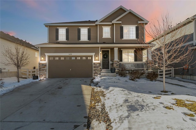 view of front of property with a porch and a garage