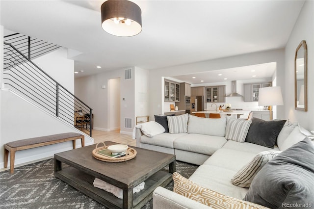 living room with hardwood / wood-style flooring and sink